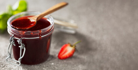 Strawberry jam in a jar sweet filling, close up