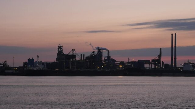 Tata Steel in IJmuiden in the early morning with smoking industrial towers