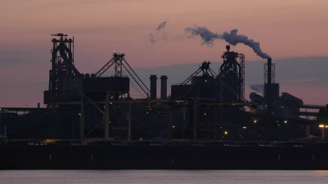 Tata Steel in IJmuiden in the early morning with smoking industrial towers