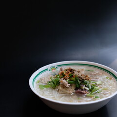 rice noodles in white clear soup topped