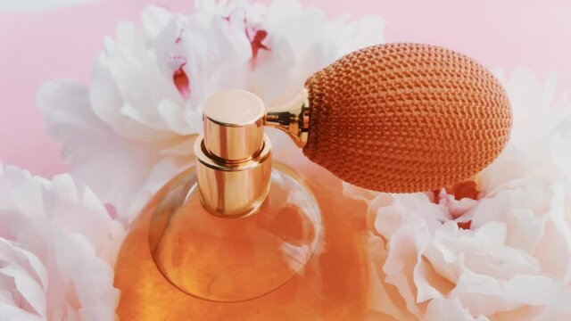 Citrus perfume bottle with peony flowers, chic fragrance scent as luxury cosmetic, fashion and beauty product backgrounds
