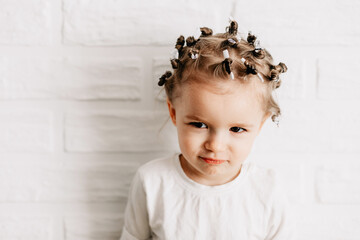 Portrait of a girl with bright sincere baby emotions. Little curly girl posing for a photo