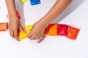 child's hands lay out air plasticine mass for modeling ultralight plasticine