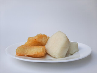 Jadah ketan, is a traditional snack from Indonesia. Made from sticky rice and grated coconut. Comparison before and after fried. On a white plate, isolated in white background