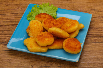 Fried chicken nuggets served salad leaves