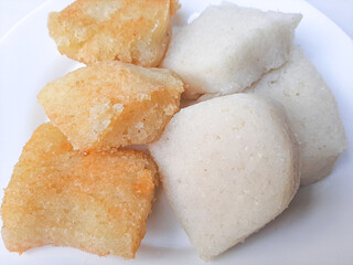 Jadah ketan, is a traditional snack from Indonesia. Made from sticky rice and grated coconut. Comparison before and after fried. On a white plate, isolated in white background