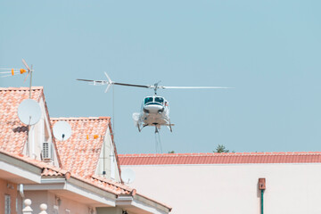 fireman's helicopter carrying water into the pool © Juan