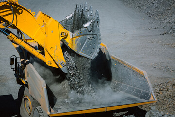The excavator works at the gold mining site.
