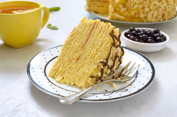 Classic Napoleon cake. A piece of delicious festive layered dessert with puff pastry and custard. Traditional russian treat