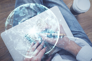Double exposure of hands and notepad with business icons.