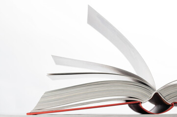 Open book with red book cover. Close-up. Side view.