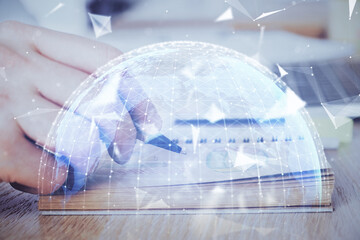 Double exposure of hands and notepad with business icons.