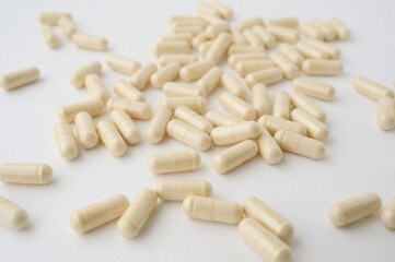 pharmacy drug capsules of vitamin medication on white table surface