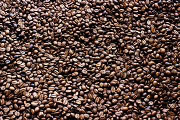 Roasted coffee beans as a background.