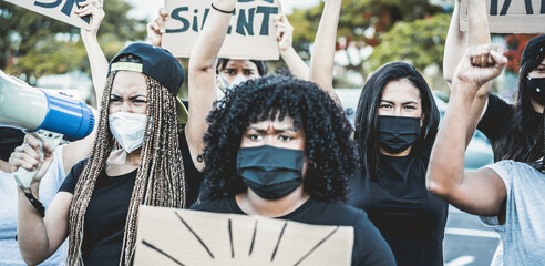 People from different culture and races protest on the street for equal rights - Demonstrators wearing face masks during black lives matter fight campaign - Focus on right girl face