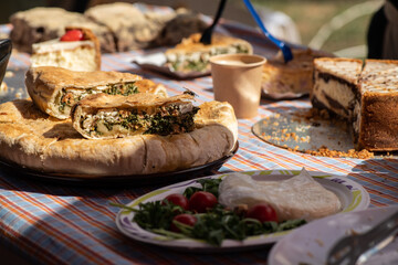 Pieces of pie with cheese, meat and vegetables on the counter at the fair  on a sunny day Kiev Ukraine