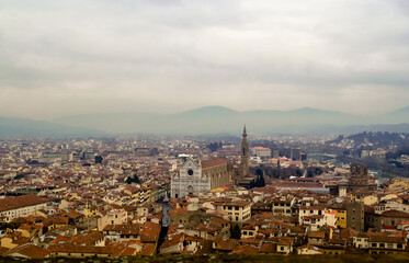 Fototapeta na wymiar Florence, Italy. A birds eye view of the city landscape toward the church of Santa Croce shot from the Arnolfo's tower in the Palazzo Vecchio