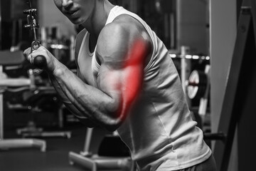 Fototapeta na wymiar Triceps specialization in bodybuilding. Man during workout in the gym