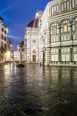Fototapeta na wymiar Florence, Italy, 2016. Duomo's square in a rainy evening, the cathedral and the baptistery lit by the street lights