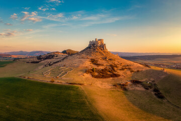Spis Zipser Castle above valley at sunset or sunrise