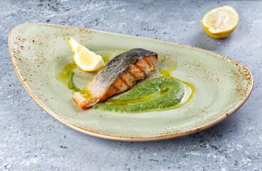 salmon steak in a plate on a gray background