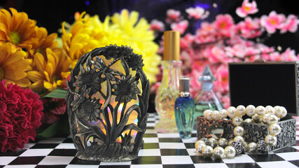 Yellow Flowers With Perfume and Jewelry on Vintage Table
