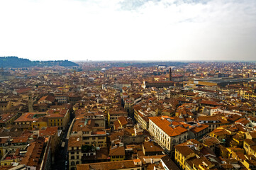 Florence, Italy. An aerial view of the city landscape seen from the bell tower of Santa Maria del Fiore church. Here you can see the train station surrounded by the typical red roofs of the town