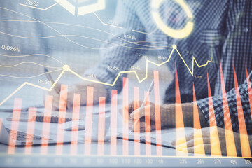 Multi exposure of forex chart with man working on computer on background. Concept of market analysis.