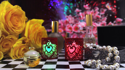 Yellow Flowers With Perfume and Jewelry on Vintage Table
