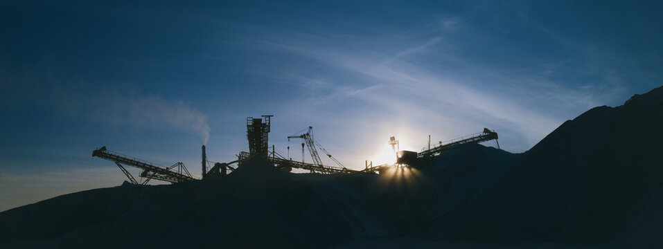 Industrial landscape. Panorama constructions of mining and processing plant on the background of the evening sky in cold colors.