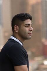 Fototapeta premium Face of young handsome Indian man thinking in the city