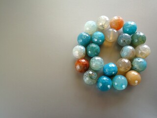 Colorful beads on gray background
