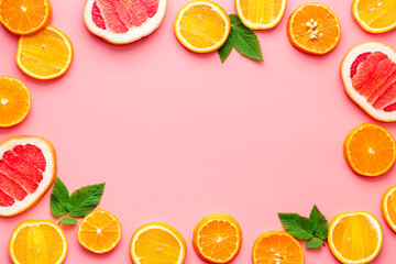Frame sliced citrus mix pink background top view