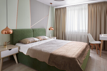 Obraz premium Modern green and beige bedroom with double bed