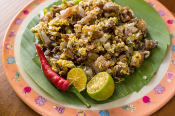 Pork sisig with mixed egg. It is a Filipino dish made from pork mask (face skin) served with...