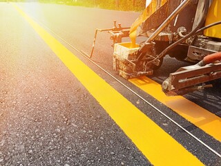 Workers are crossing a line of yellow double solid lines.
