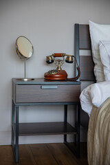 retro telephone stands on a wooden table in a hotel room