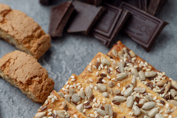 Cookies and dark chocolate on concrete textured background.