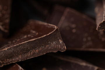 Dark chocolate cracked pieces closeup macro