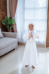 Fototapeta na wymiar beautiful muslim toddler smiling with greeting gesture