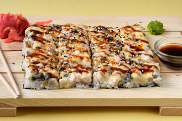 Japanese baked sushi pizza with, snow crab, cheese, wasabi, soy sauce and marinated ginger. Restaurant or cafe menu images.