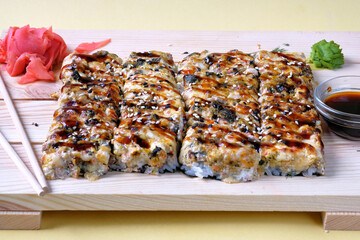 Japanese baked sushi pizza with, snow crab, cheese, wasabi, soy sauce and marinated ginger. Restaurant or cafe menu images.