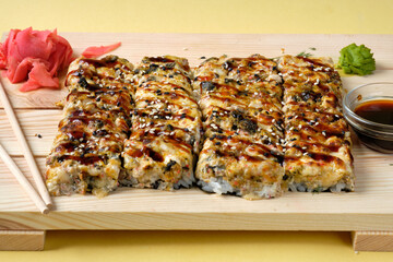 Japanese baked sushi pizza with, snow crab, cheese, wasabi, soy sauce and marinated ginger. Restaurant or cafe menu images.