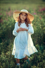 Happy girl with hat in a summer field