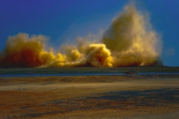 Dust storm after detonator blasting in the Arabian desert 