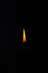 Candle light, isolated on a black background, burning candle. Sorrow. A loss.