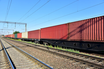 Fototapeta na wymiar Cargo Containers Transportation On Freight Train By Railway. Intermodal Container On Train Car. Rail Freight Shipping Logistics. Import - export goods from Сhina
