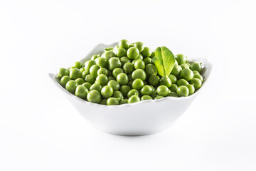 Green raw peas in pocelain bow isolated on white background
