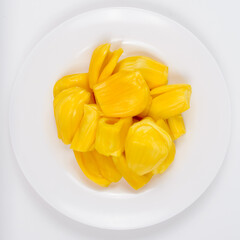 Ripe jack fruit slices against white background