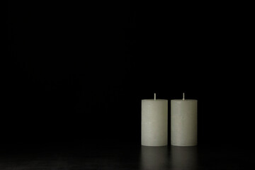 two candles on a black background with copy space sorrow farewell concept